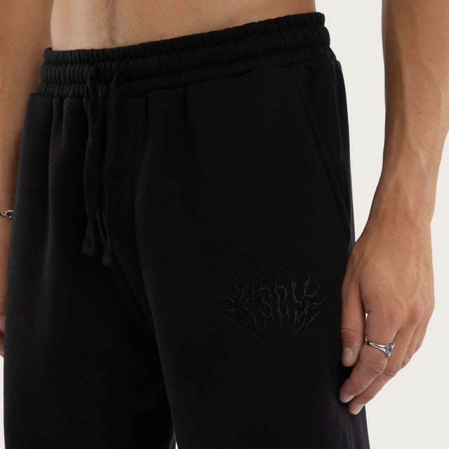 Model wears Frenzy Trackpant Jet Black Trackpants in Black - Image 6
