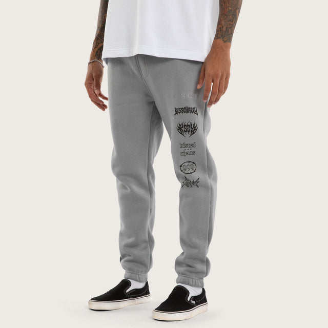 Model wears Sinner Trackpant Ultimate Grey Trackpants in Grey - Image 1