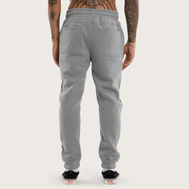 Model wears Sinner Trackpant Ultimate Grey Trackpants in Grey - Image 5