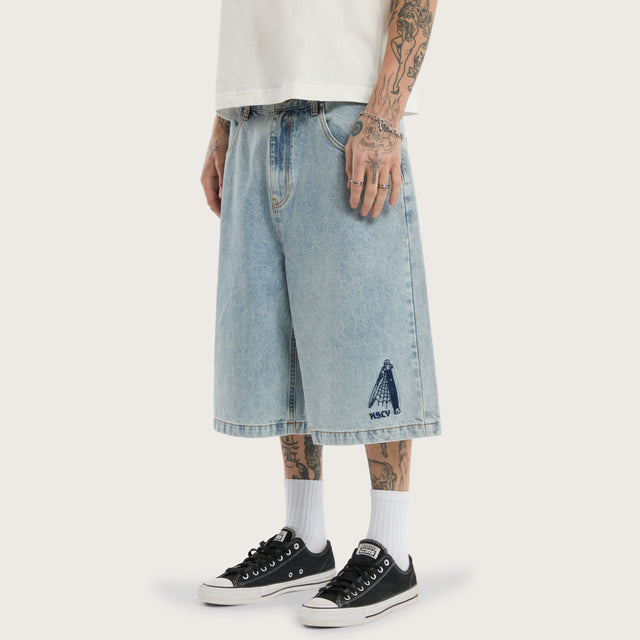 Model wears K7 Super Baggy Jorts Light Blue Shorts in 0 - Image 1