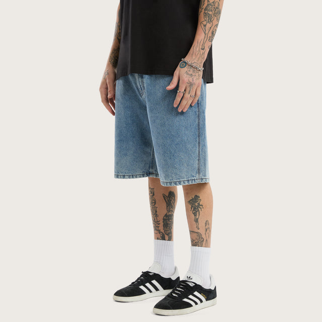 Model wears K6 Denim Jort Trashed Blue Shorts in 0 - Image 1