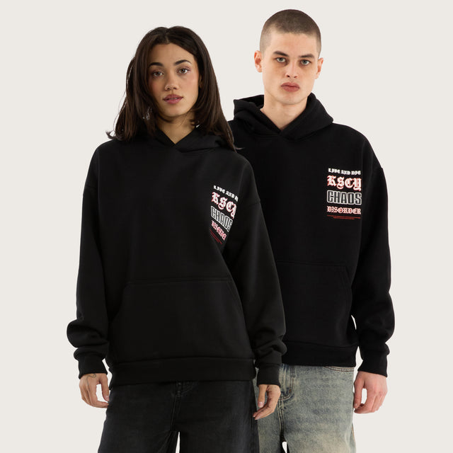 Model wears Trap Oversized Hoodie Jet Black Hoodies in Black - Image 1