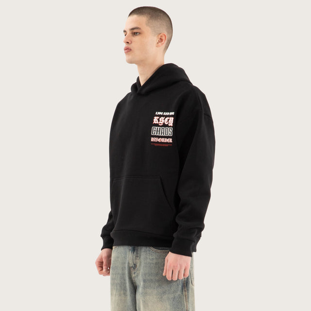 Model wears Trap Oversized Hoodie Jet Black Hoodies in Black - Image 4