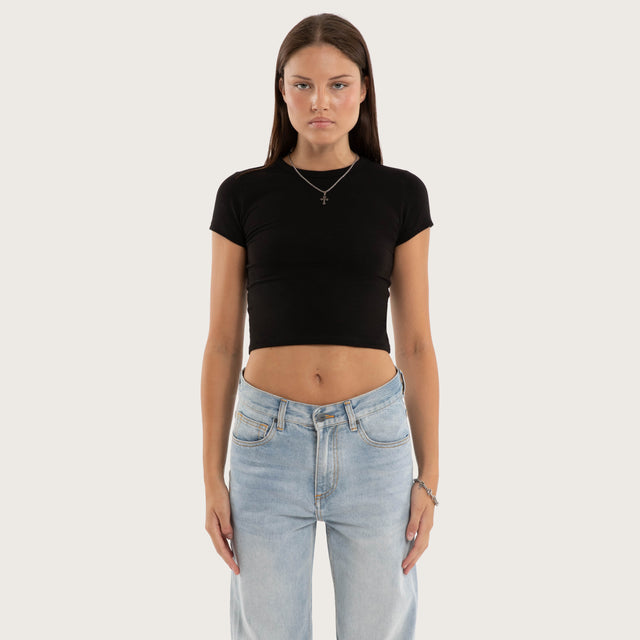 Model wears Roux Baby Tee Jet Black T-Shirts in Black - Image 1