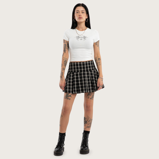 Model wears Tempest Pleated Skirt Black/White Check Skirt Black – image 3