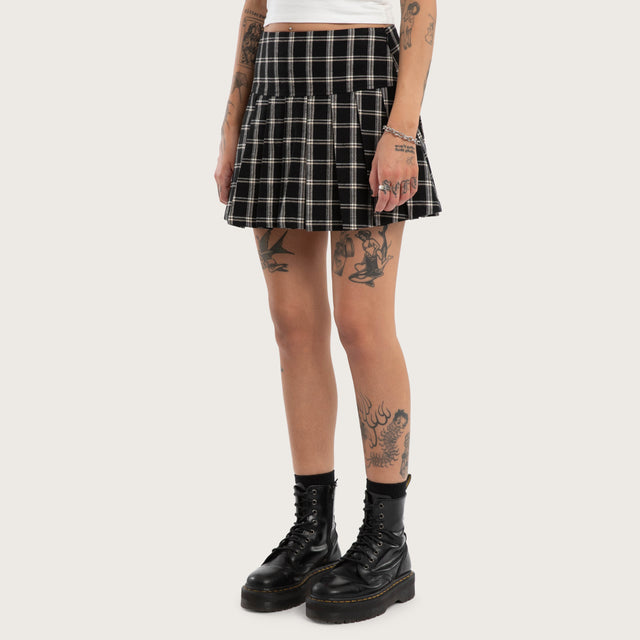 Model wears Tempest Pleated Skirt Black/White Check Skirt Black – image 1